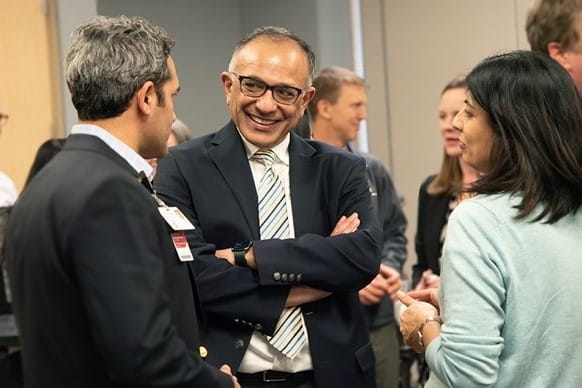 faculty speak together during a social event