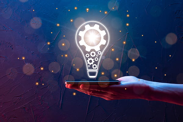 a lightbulb hovers over a laptop