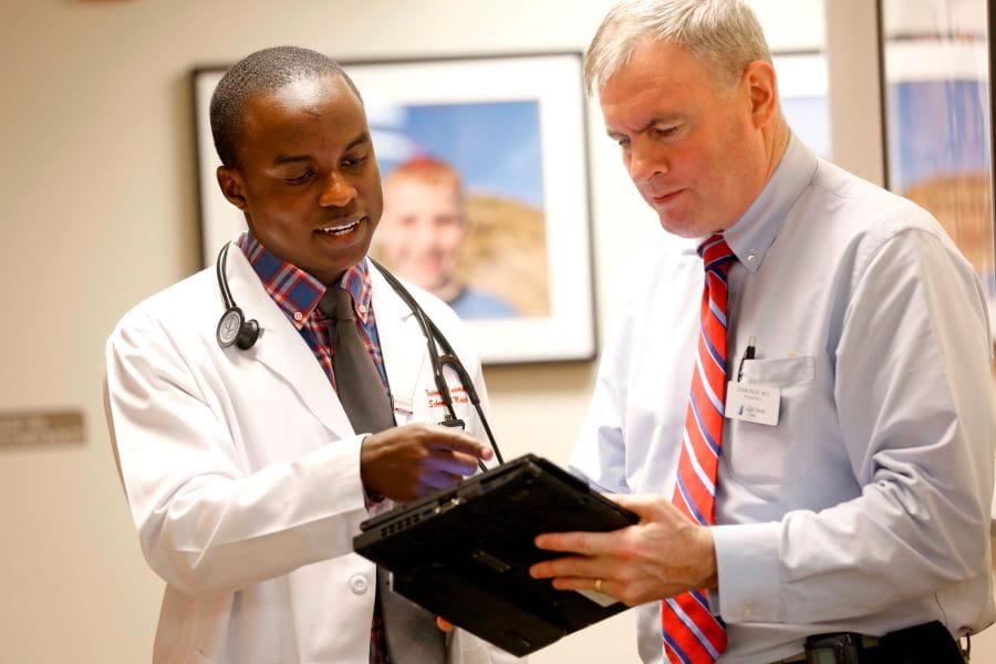 a student and a faculty member review a document together