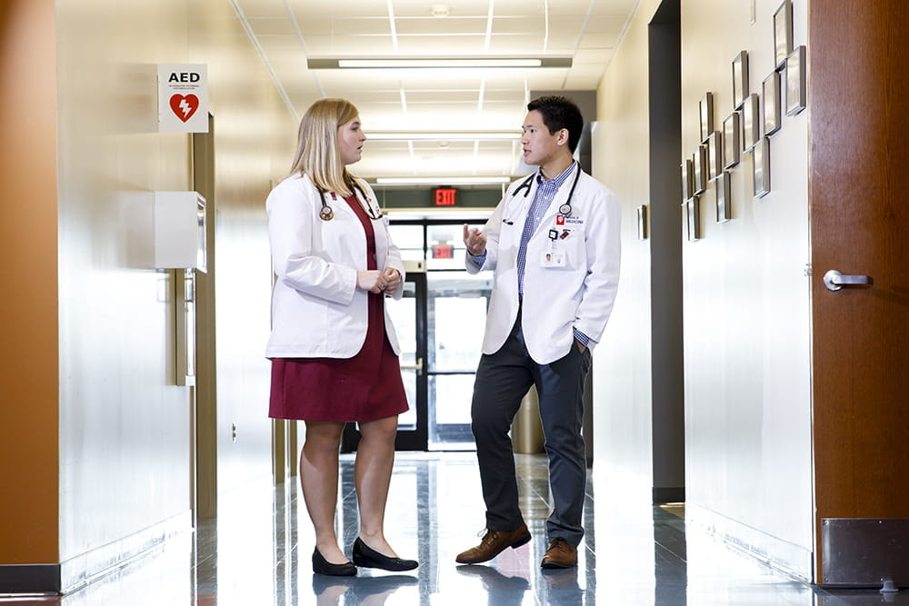 A pair of physicians has a conversation in the hallway at the IU School of Medicine in Fort Wayne, Indiana.