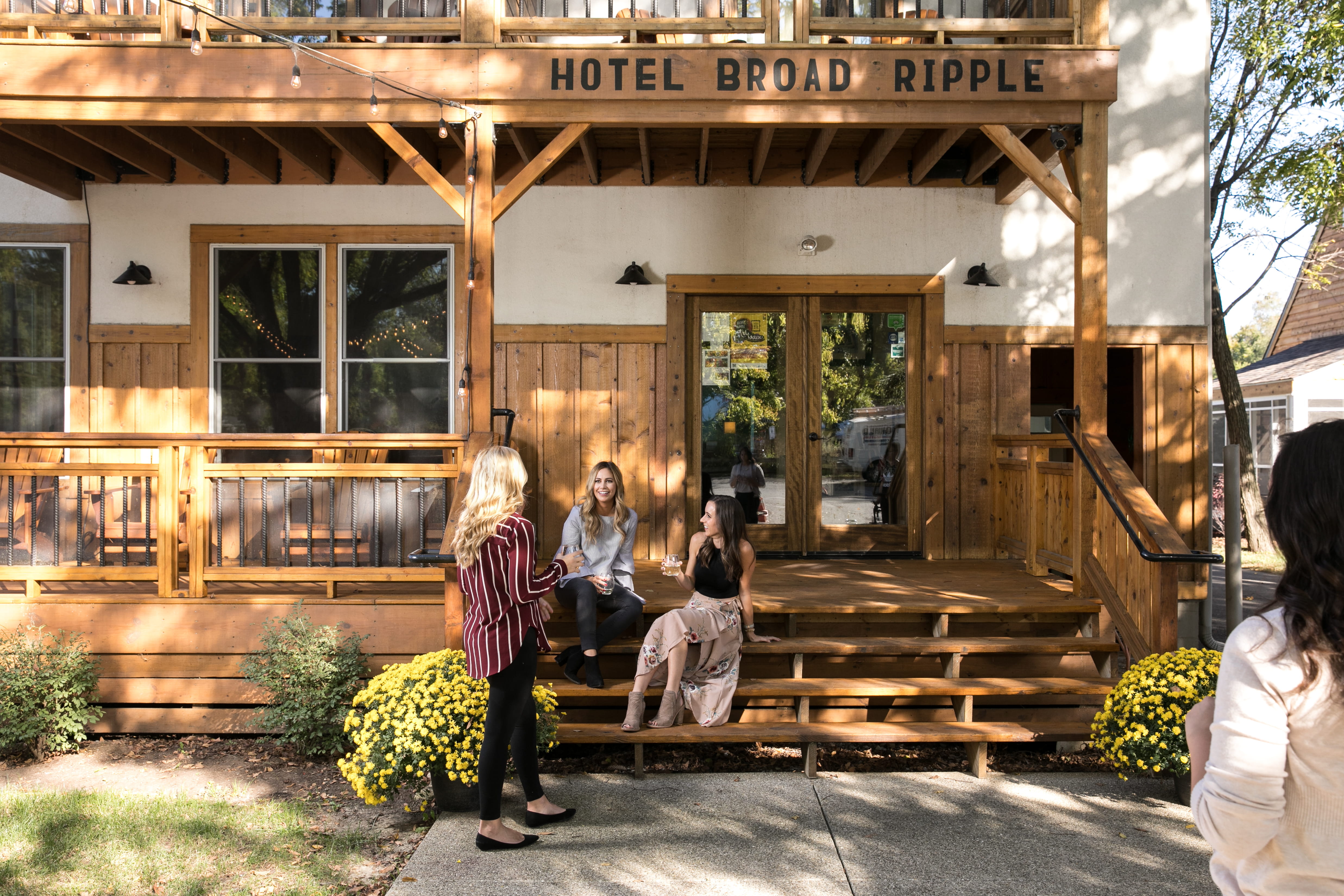 people sit together on a shady porch