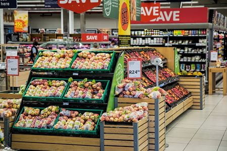 crates of fruits and vegetables in a grocery store