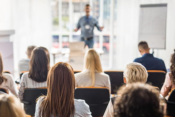 An instructor teaches a group of business professionals.