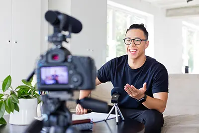 A man engages talks in front of a video camera