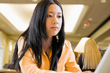 a woman works studiously