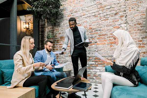 A group of professionals gathers to collaborate and produce scholarly work