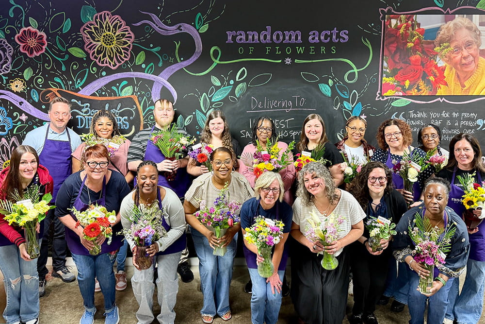 The FAPD staff poses for a group shot during a team outing at Random Acts of Flowers, where they created bouquets of flowers for patients at IU Health and other facilities.