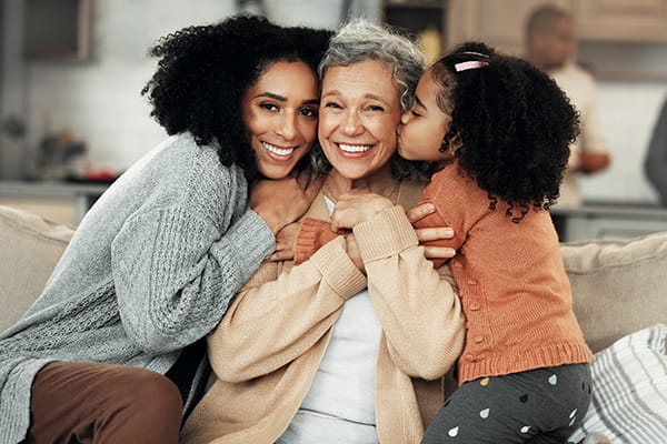 Mother, grandmother and daughter hugging