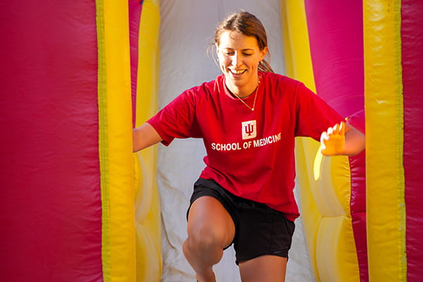 A medical student runs through an obstacle course