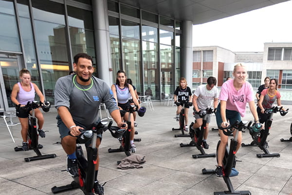 Students exercise during a spinning class