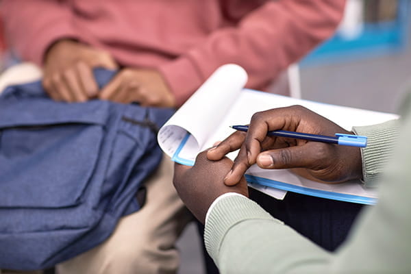 A close-up of two people's hands during a counseling session