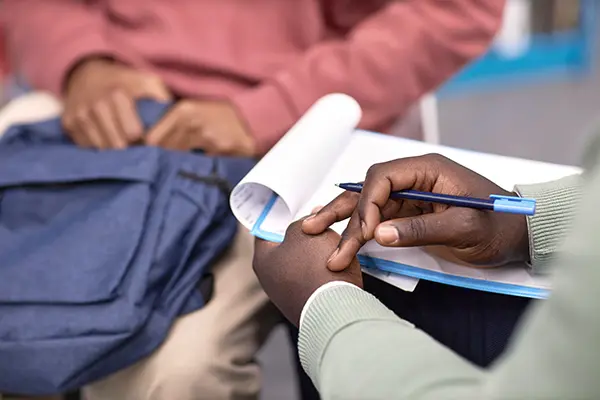 A close-up of two people's hands during a counseling session