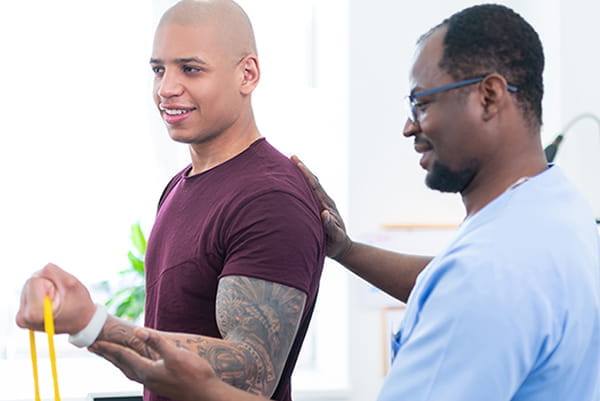 A physical therapist works with a patient