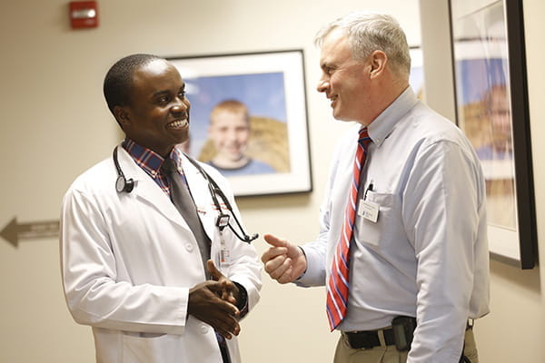 A faculty member speaks with a trainee at IU School of Medicine South Bend Clinic