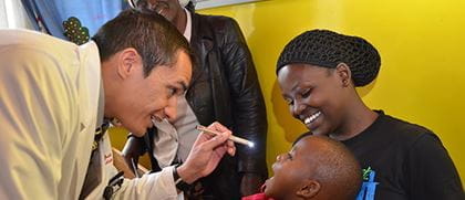 a doctor examines a young child's eyes