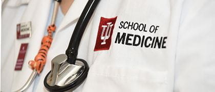 close up photo of white coat and stethoscope