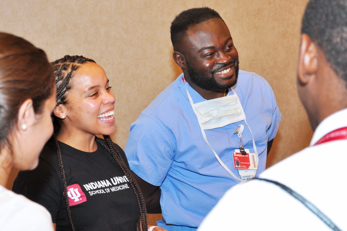 trilliah fazle and mahmud sam, two black medical students, speak to visitors at an event