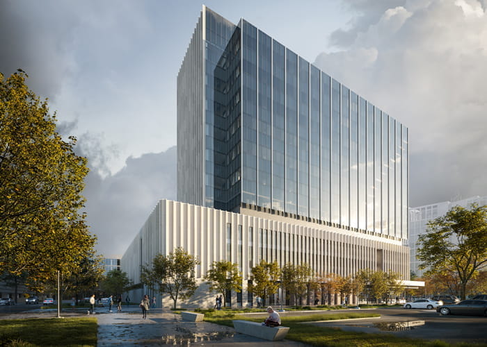 exterior view of the new building shows a large glass tower over a limestone base