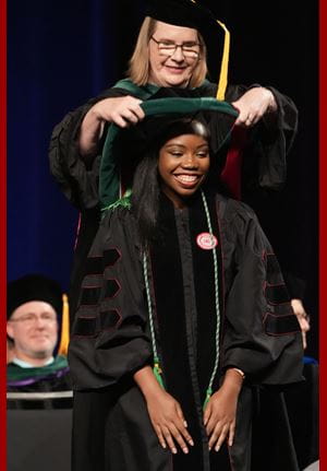Okoruwa being hooded at the IU School of Medicine Graduate Recognition ceremony Okoruwa being hooded at commencement ceremony