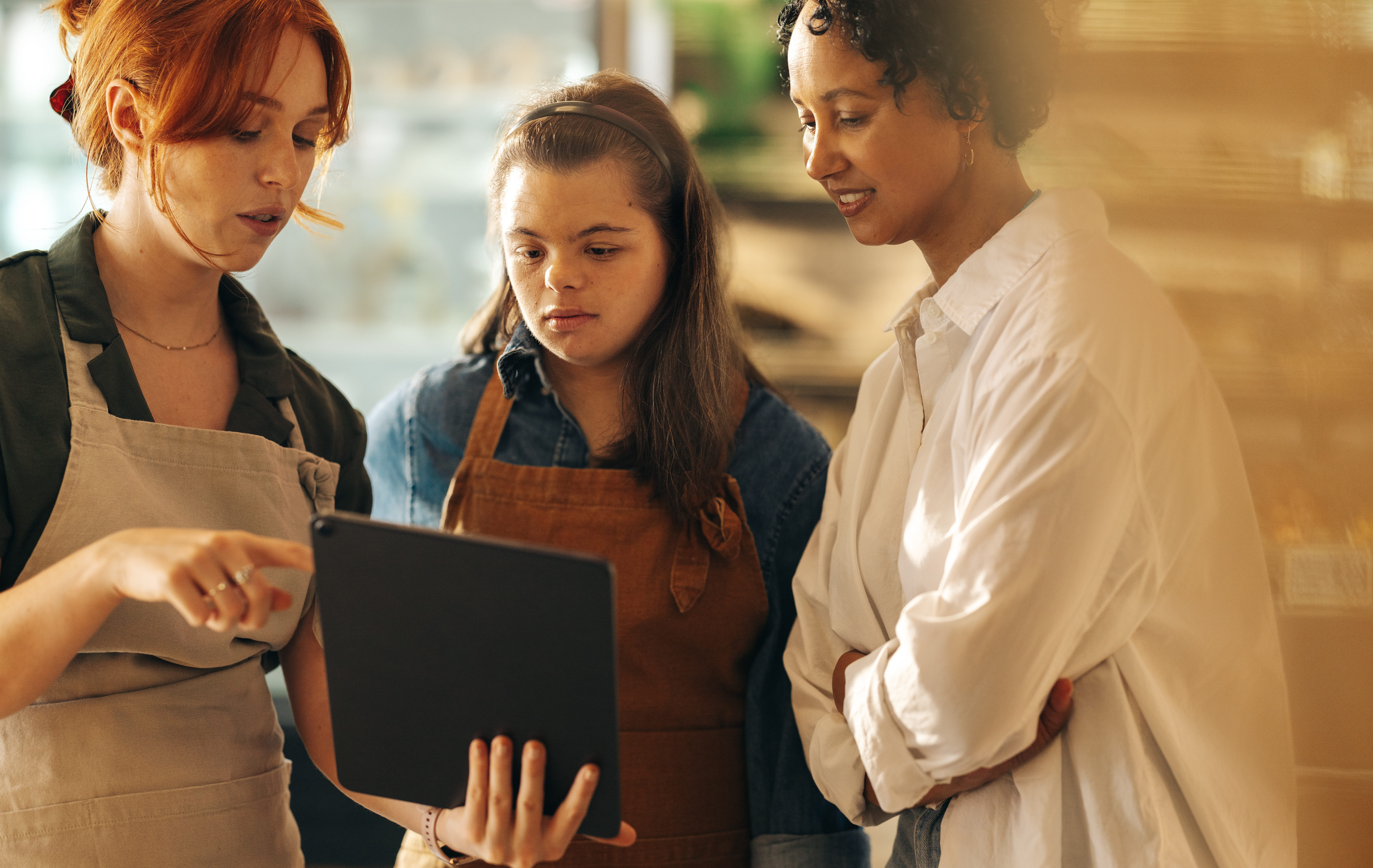 three women at work in a grocery store