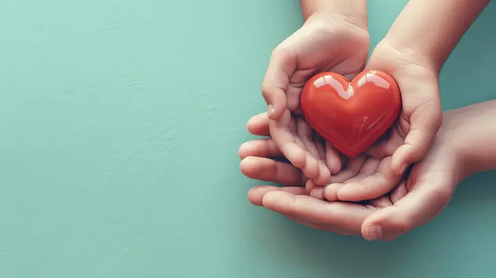 adult hands holding child's hands that are holding a heart