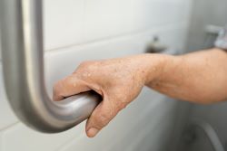hand holding a rail in a bathroom