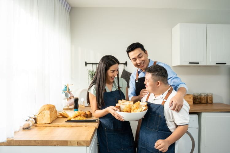 family cooking bread in kitchen