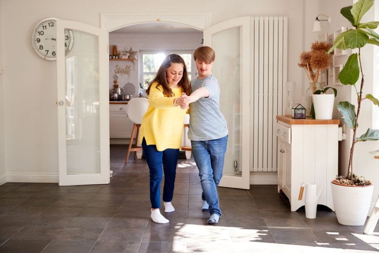 young down syndrome couple dancing in living room