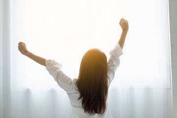 woman stretching in sunlight