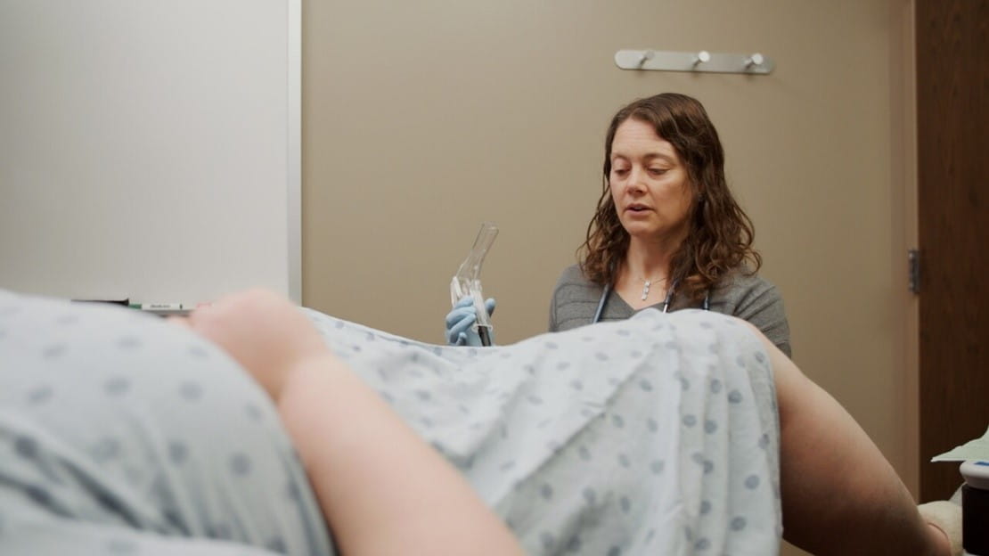 female doctor performing a female exam
