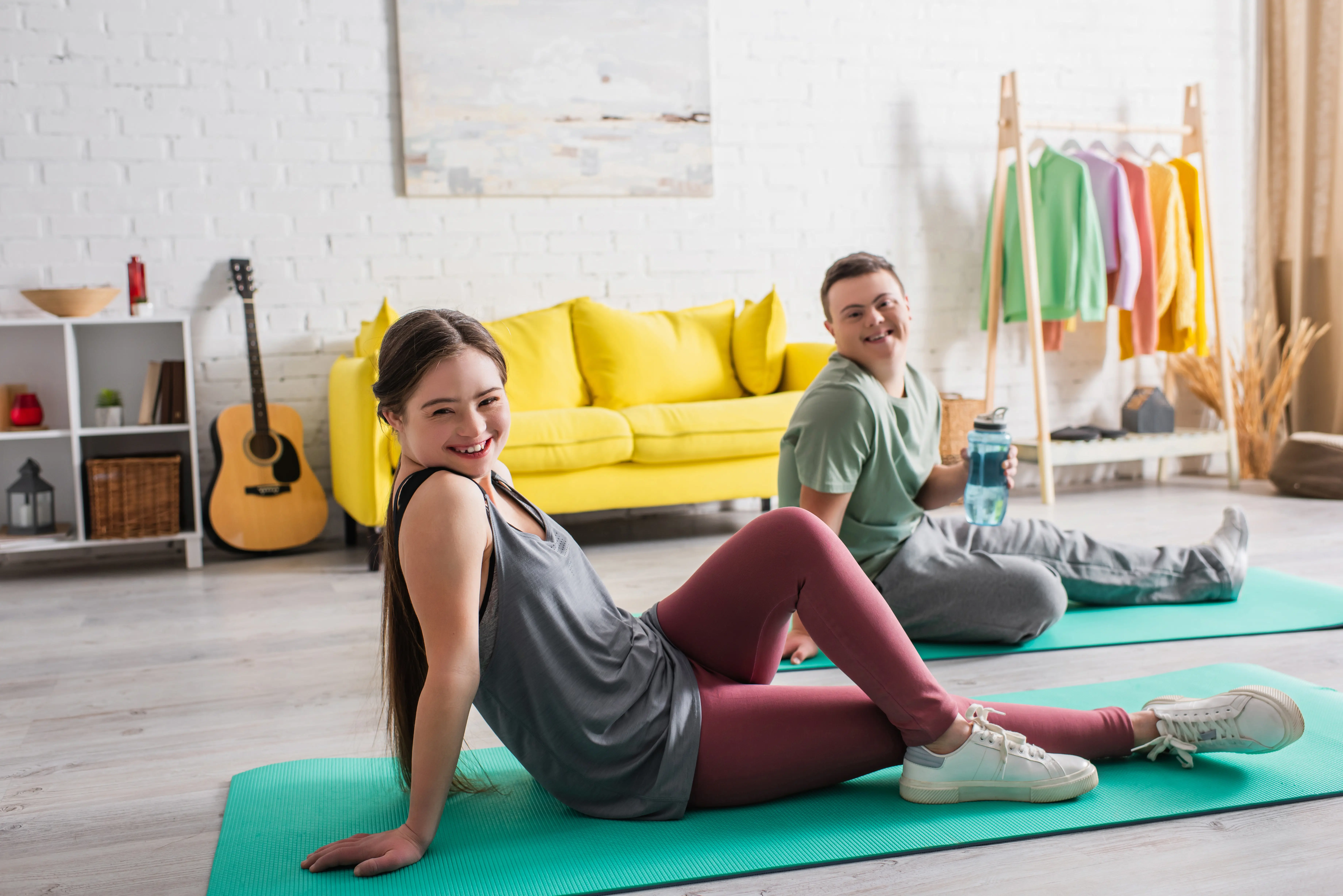 male and female working out in their living room