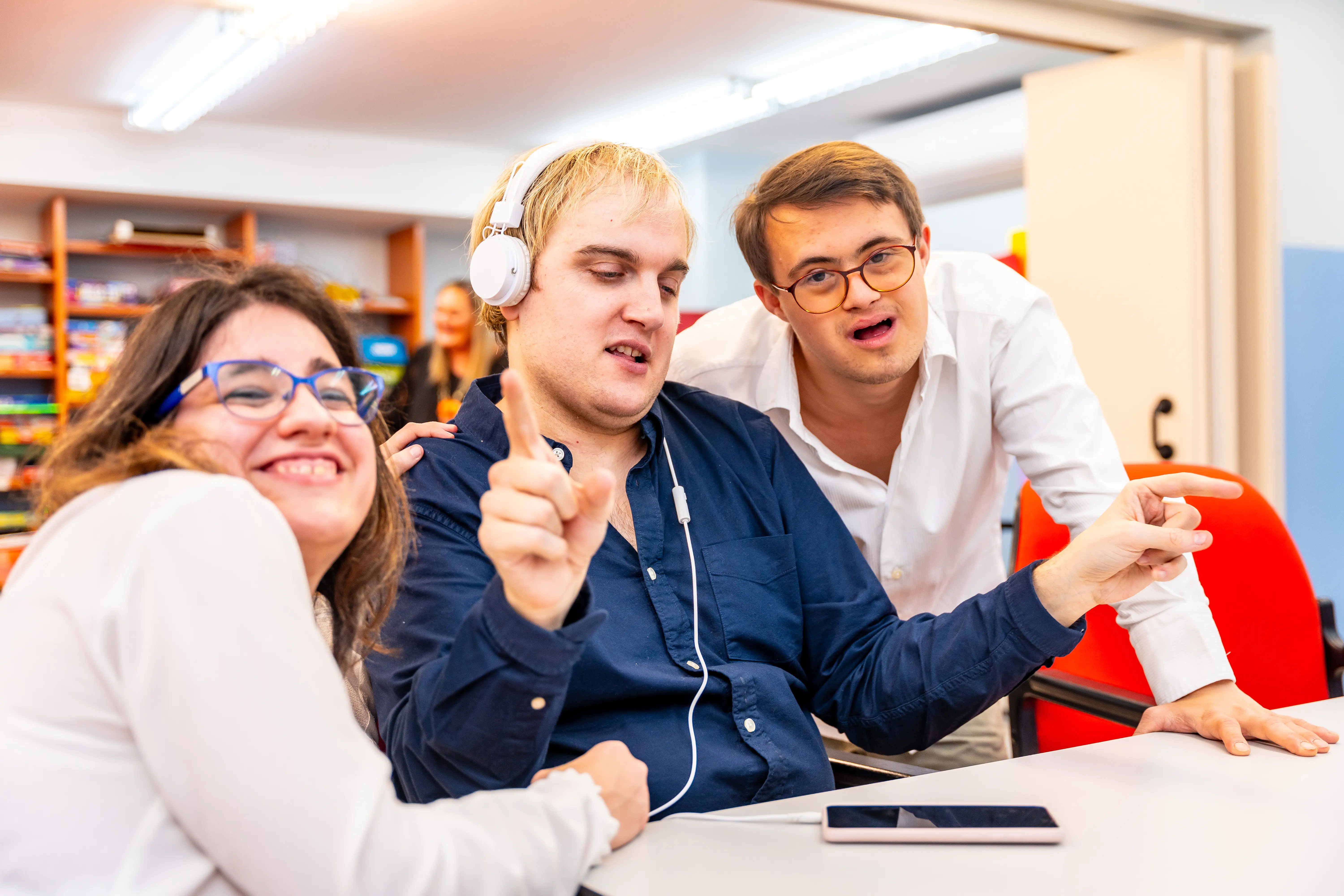 three people listening to music
