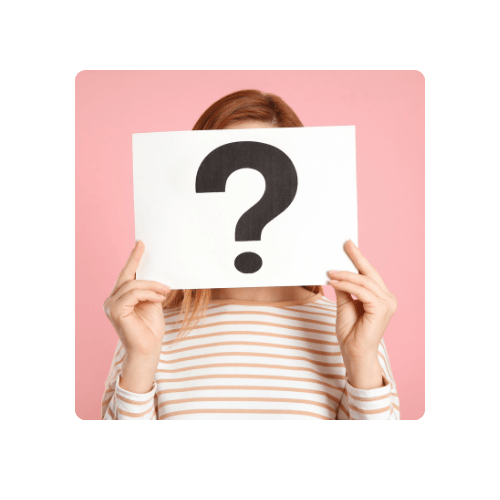 female holding a question mark on a piece of paper in front of her face