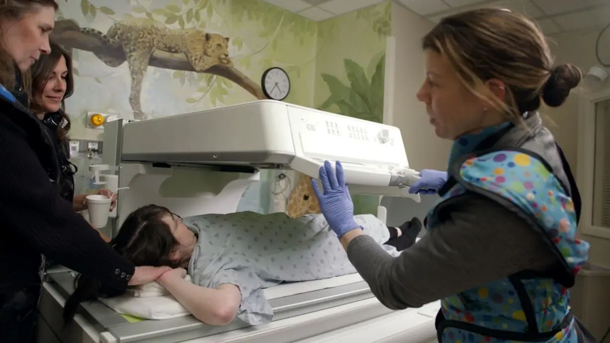 image of pt getting a radiology exam with several support people surrounding them