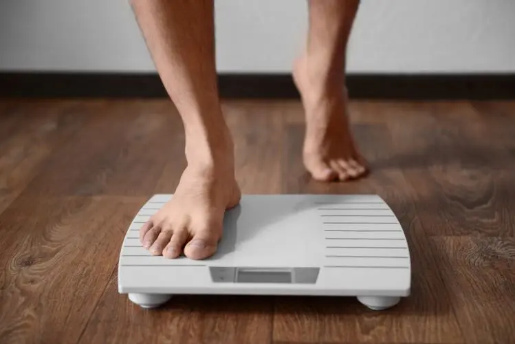stepping on a white scale