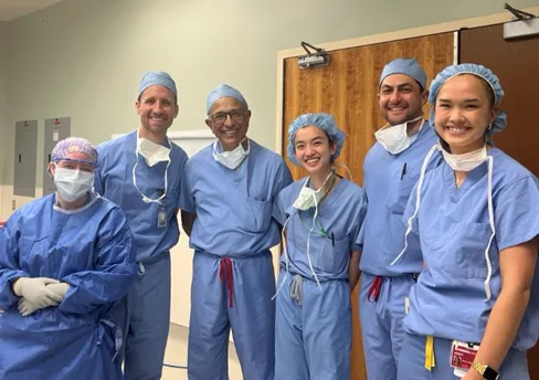urology research team in scrubs and surgical masks