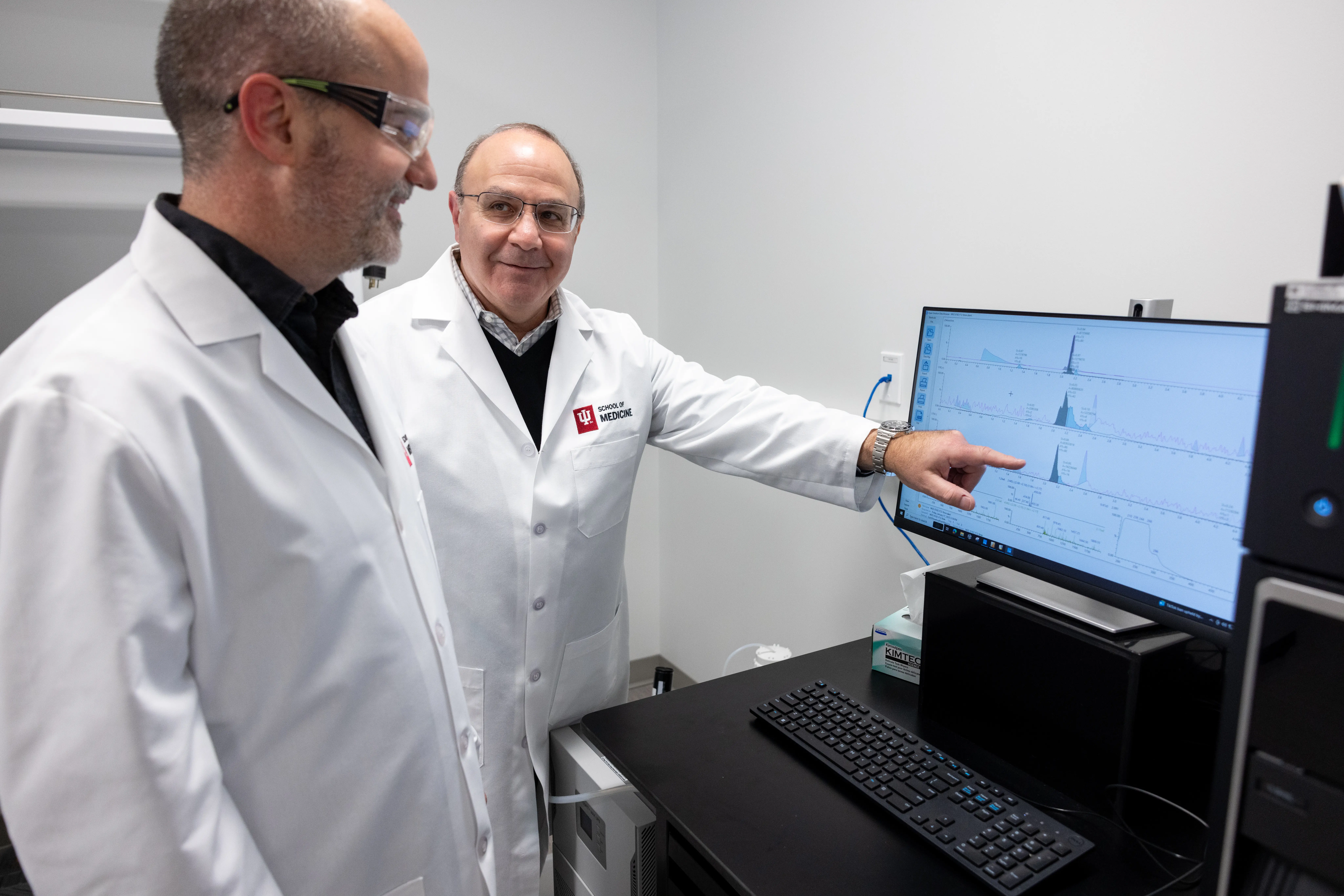 Doctors reviewing data on computer screen