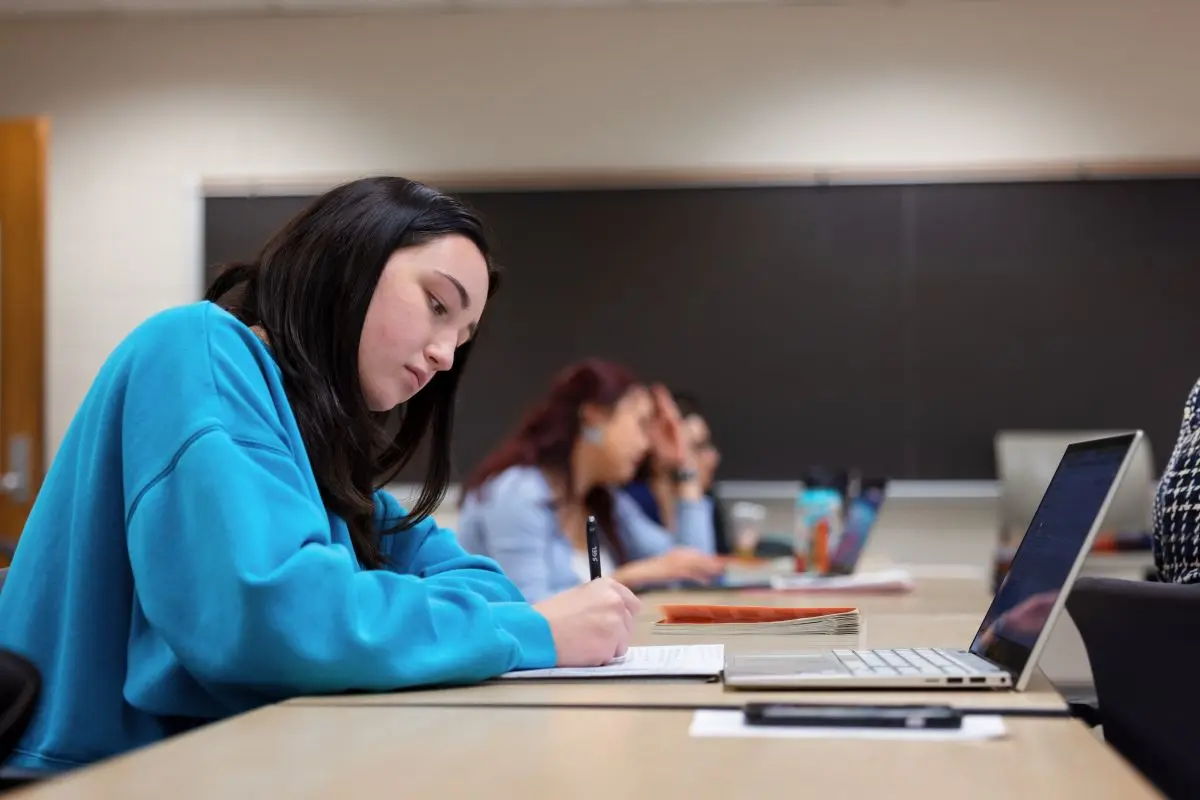 Student studies at computer in classroom