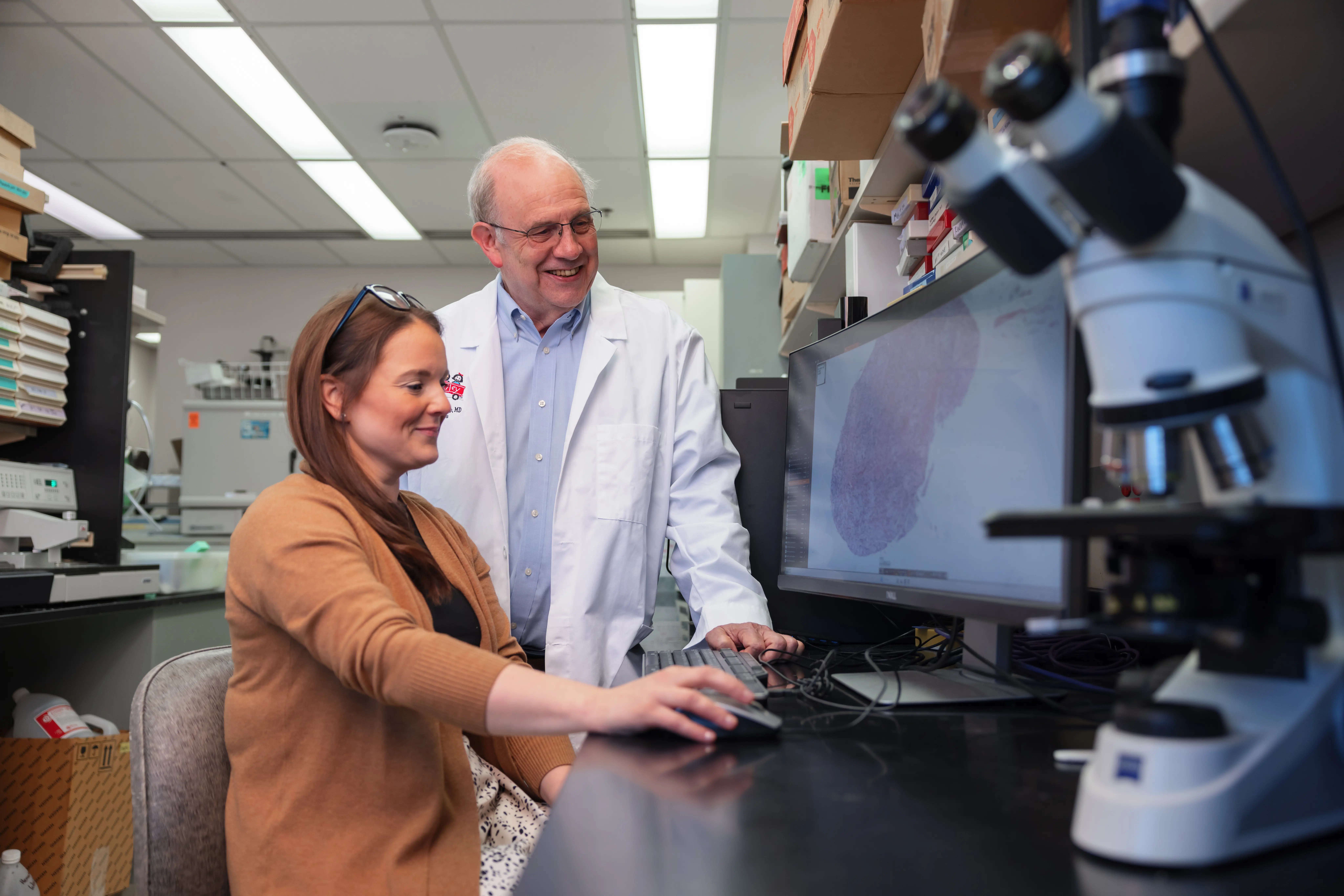 Physician and researcher in lab review data