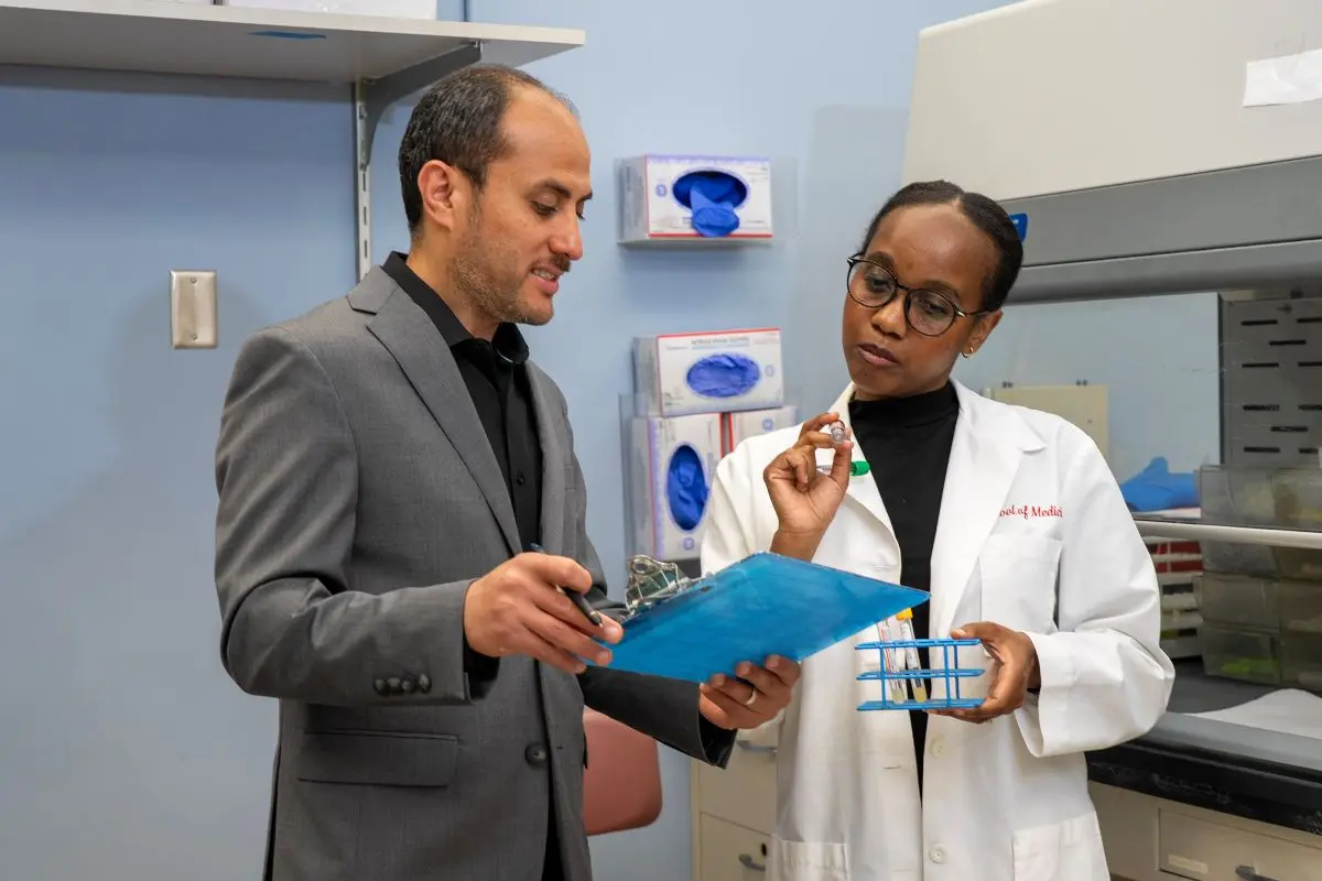 Two people are discussing lab results in a hospital setting