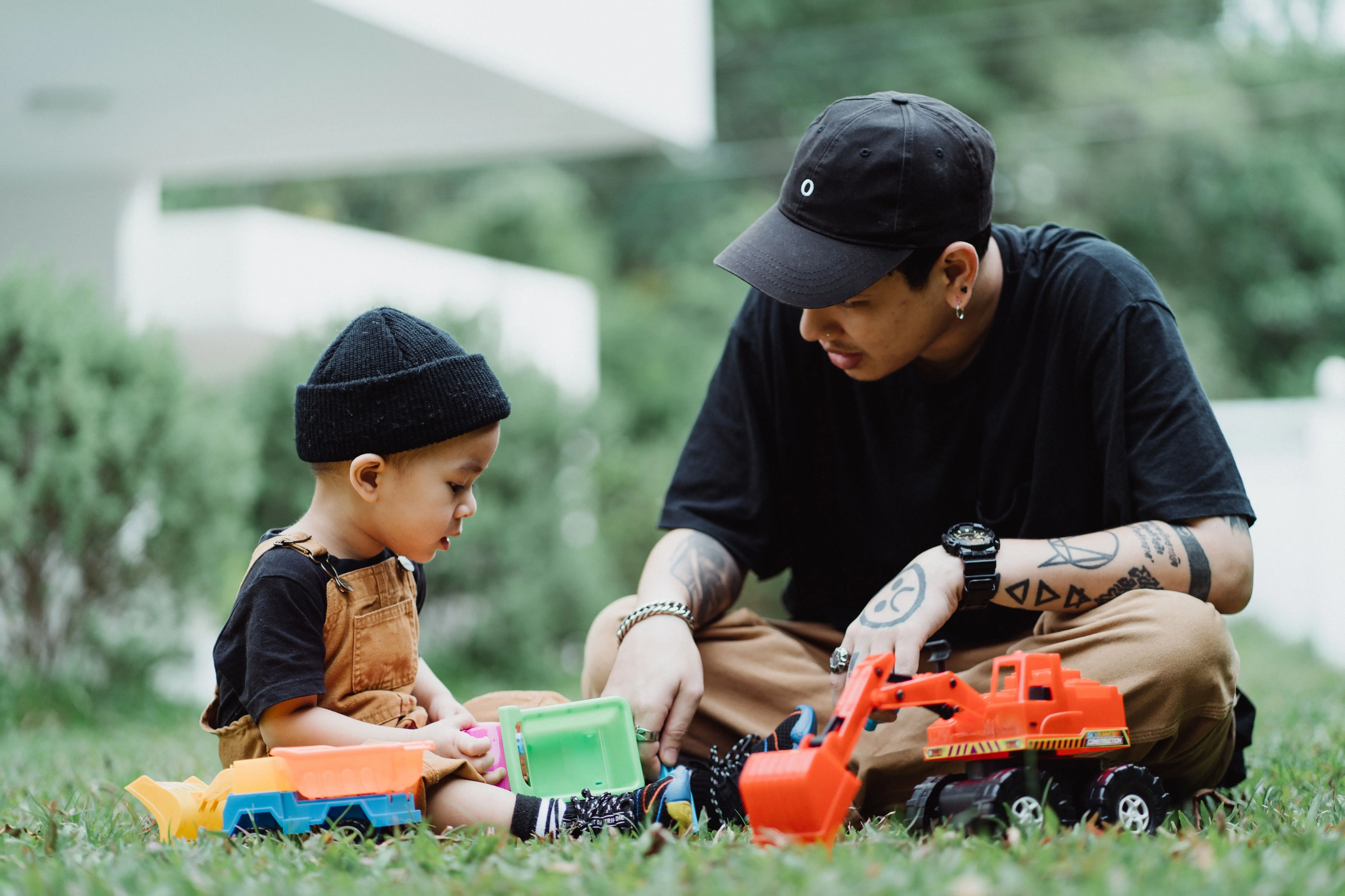 Father and son play in the grass