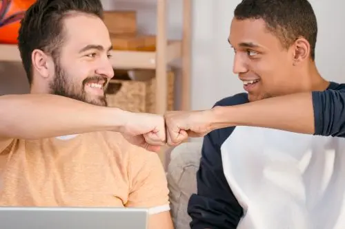 two males fist bumping