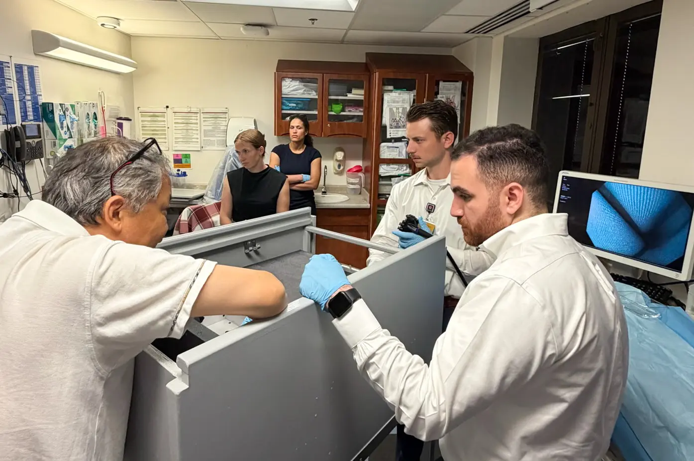 gastroenterology fellows getting a demonstration and introduction to endoscopy with tools led by Dr. Hak Nam Kim.