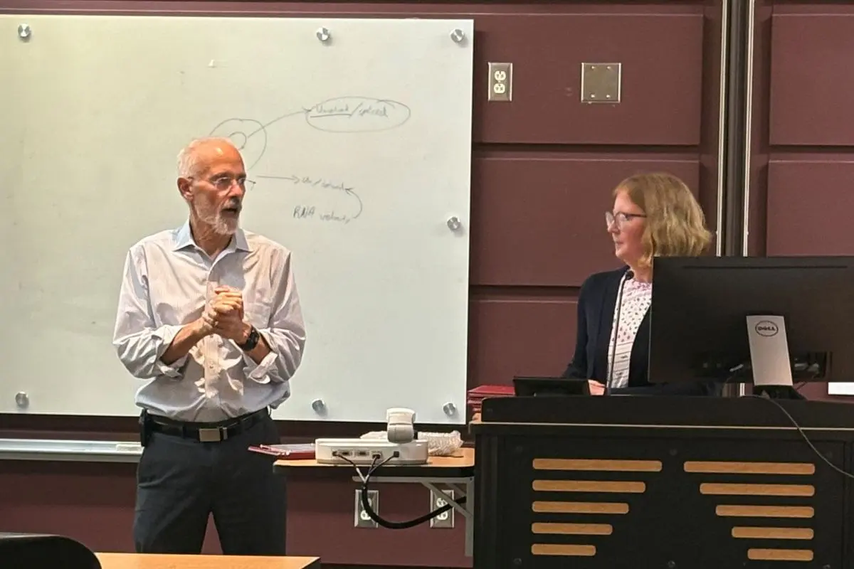Two people are presenting during a graduation celebration.