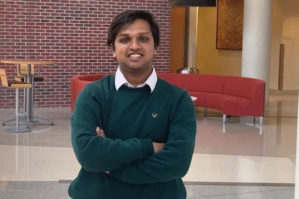Moksh Khetan standing with his arms folded. 