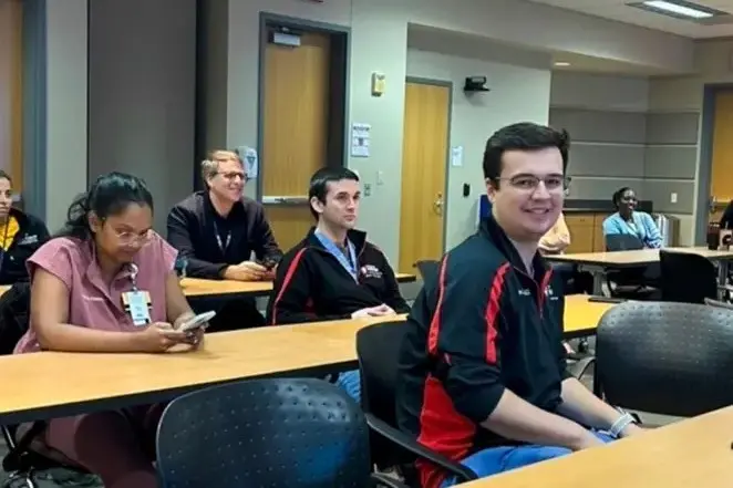 Fellows seated in a classroom-style conference room participating in an educational session.