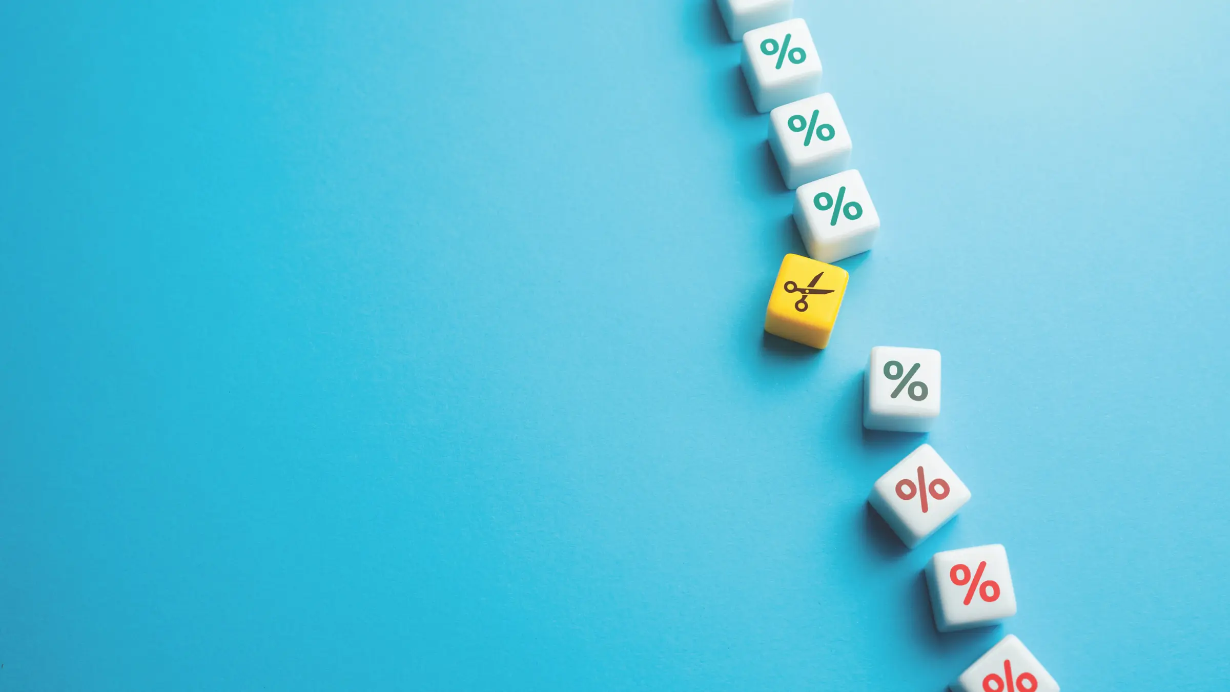 illustration of percentage signs going from green down to red, with a pair of yellow scissors breaking the line in the middle
