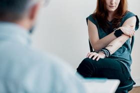 woman patient facing doctor/psychologist