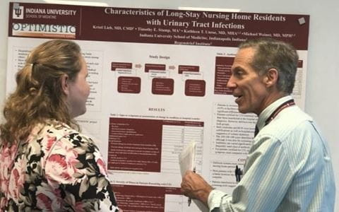 Kristi Lieb and Tom Imperiale speak during a poster presentation.