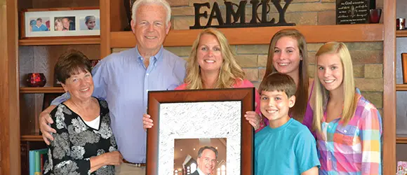 bigelow family holds a photo of their loved one